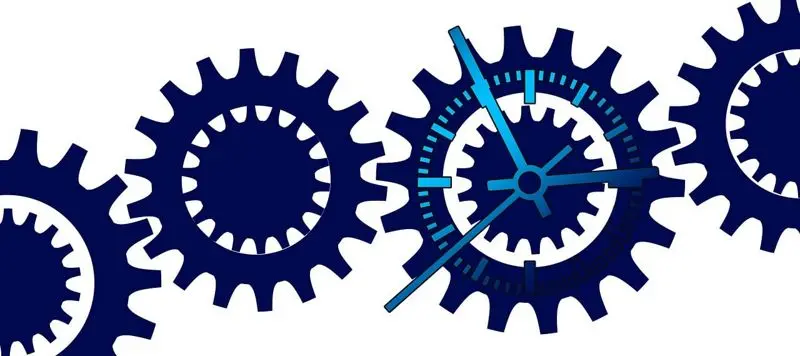 Four interlocked gears, one of them has a clock face.